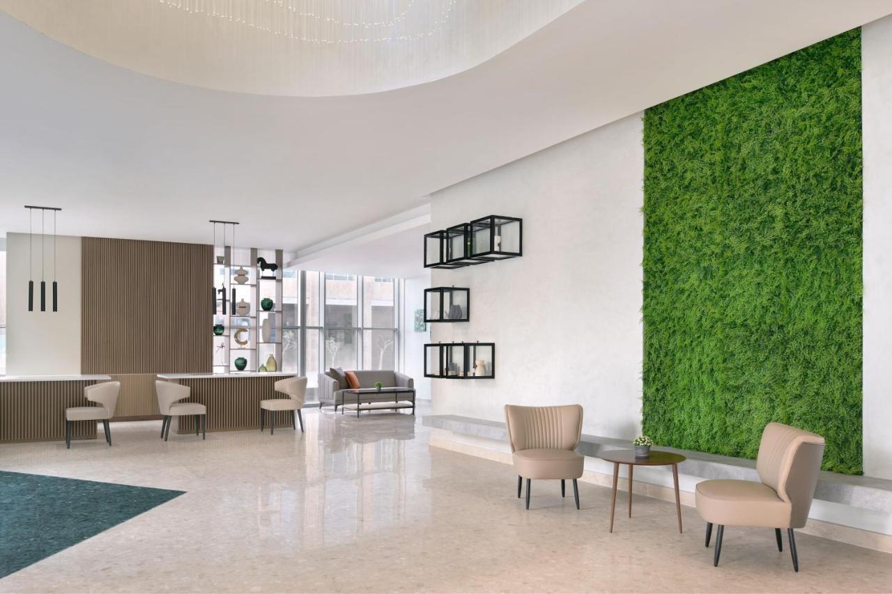 Отель Element By Westin West Bay Доха Экстерьер фото A green wall in a hotel lobby